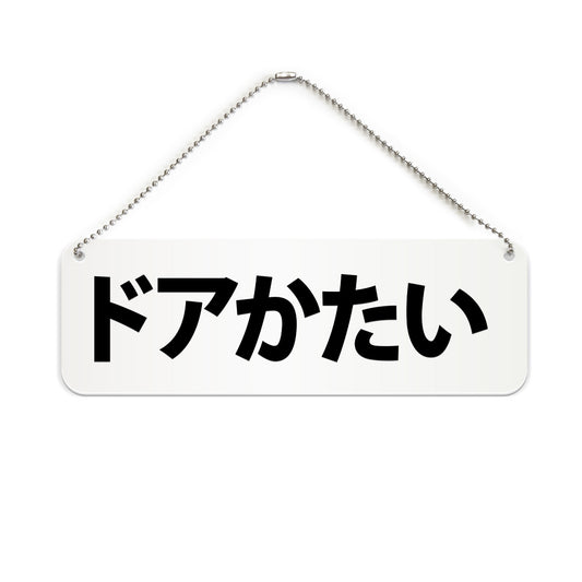 ドアかたい と書かれた横長プレート看板（白いアクリル板・黒文字）